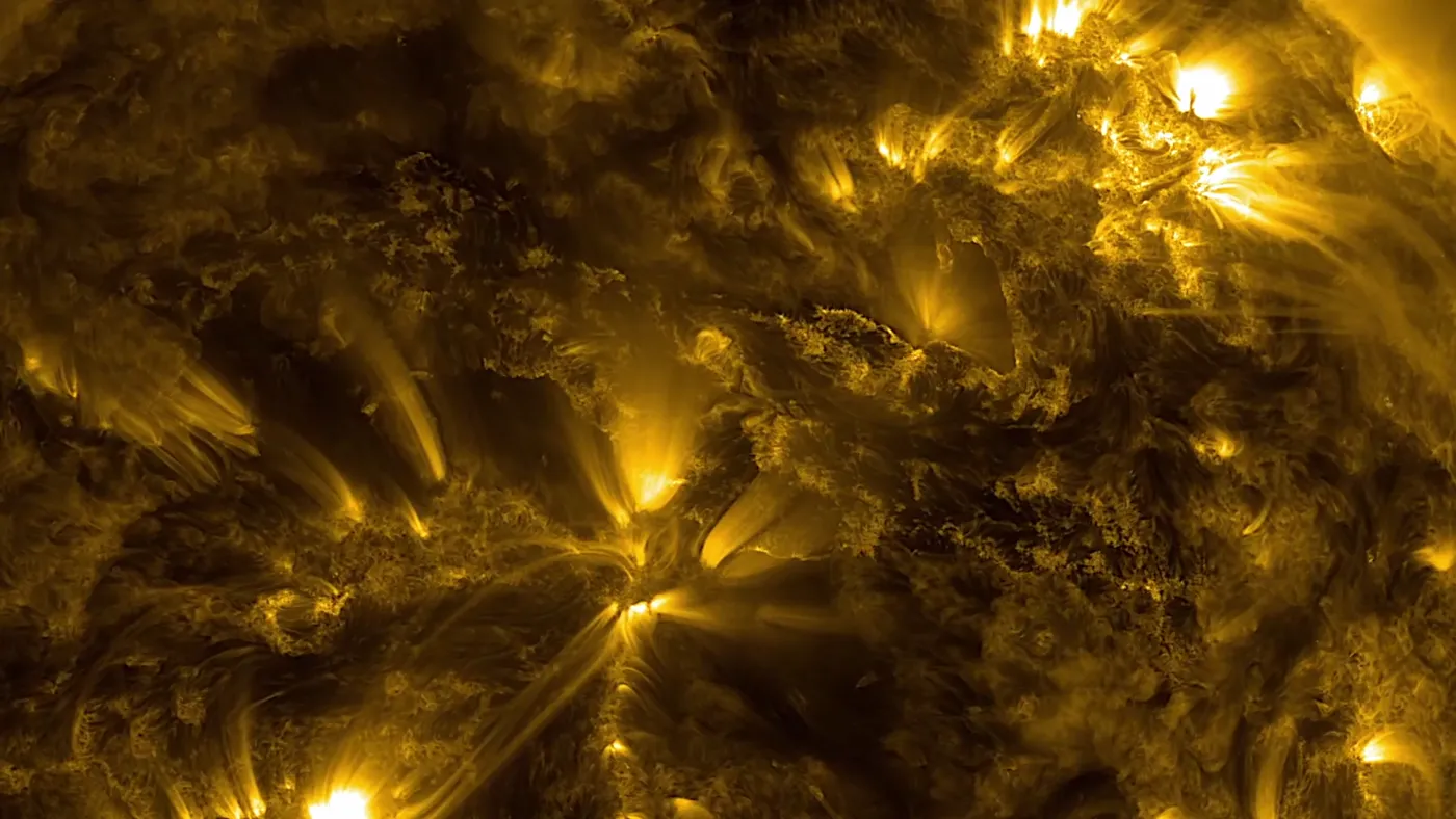 Close-up of the Sun’s surface: loops of glowing plasma rising off it